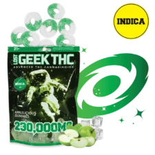A standing pouch of Lost Geek THC “Applelicious Gummies 230,000 MG .5 lb 8 oz” with a black-and-green astronaut graphic; above the pouch are sugar-coated green-and-white ring gummies; to the right, a green swirl graphic and green apple slices on melting ice cubes; a yellow circle in the upper right reads “INDICA.”